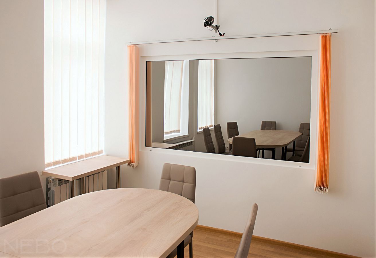 Зеркало Гезелла в окне-перегородке между двумя комнатами в научно-исследовательском учреждении