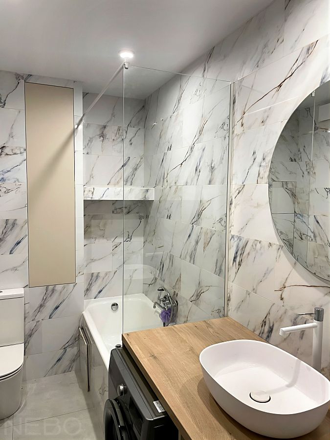 Стеклянная перегородка на торец ванны с круглой белой штангой для навески тканевой шторки