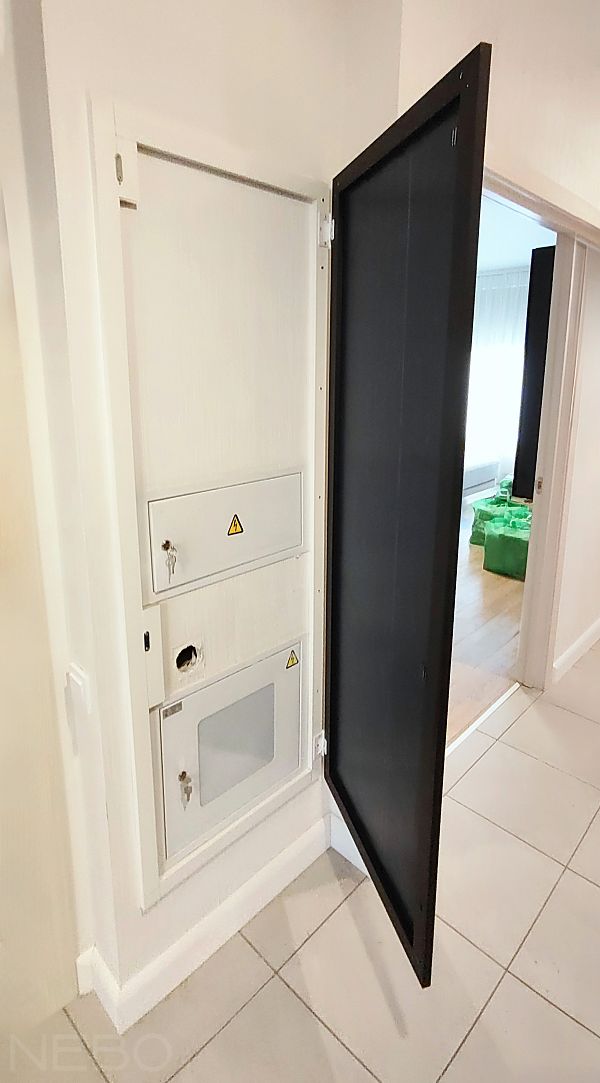 Зеркало-створка на петлях в черной тонкой рамке для скрытия щитка в коридоре прихожей
